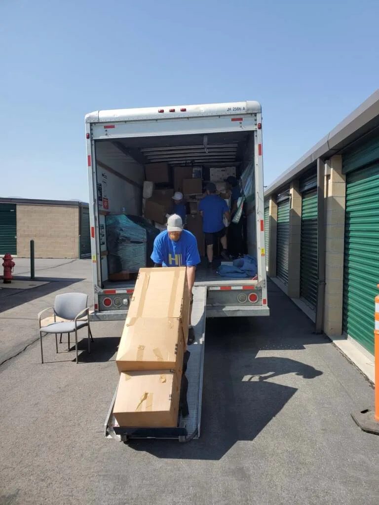 Heavy Lift crew moving wrapped furniture